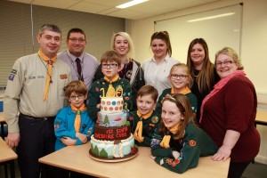 1st South West Cheshire District beaver Henry Duncan (6), and cub scouts George Duncan (9), Brodie Evans (7), Aaliyah Wilson (8) and Hannah Evans (9) receive the cake from Reaseheath head of Food Nick Blakemore, Sam Copeland and students Katie Brittleton, Susan Thomas and Hayley Clibborn 