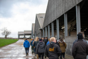 The Holstein UK ADTP group walks through a modern dairy unit. Visits included industry leaders like Thomasson Farms and Grosvenor Farms, showcasing the latest in technology and youngstock management.