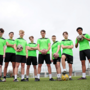A group of Reaseheath Men’s 1st Team football players in their team kit, standing together on the training pitch ahead of the Cheshire County Cup Final.